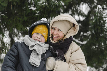 Happy mother and son together at winter forest - SEAF00419