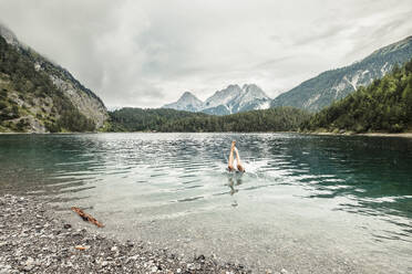 Man swiming in Blindsee lake by Mieming Range, Tirol, Austria - WFF00640