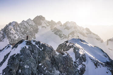 Climber standing on Vorderer Tajakopf mountain, Ehrwald, Tirol, Austria - WFF00643