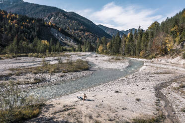 Man sitting by river Rissbach, Hinterriss, Tirol, Austria - WFF00655