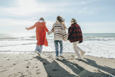 Carefree friends enjoying at beach on weekend - OMIF00493