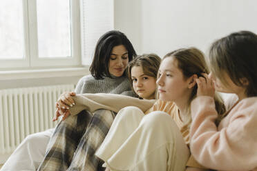 Women with their daughters in living room at home - SEAF00447