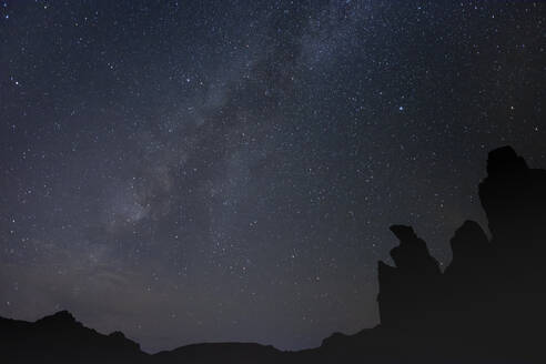 Spain, Tenerife, Milky Way galaxy against night sky over Roques de Garcia in Teide National Park - HLF01272