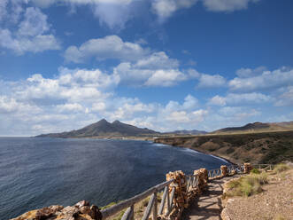 Spain, Province of Almeria, Isleta del Moro, Coastal footpath in Cabo de Gata with mountains in background - LAF02740