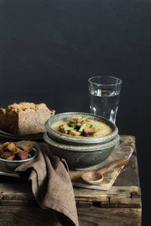 Jerusalem Artichoke soup garnished with croutons and scallions in bowl - EVGF03989