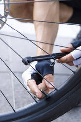 Cyclist inflating tire with tool - IFRF01508