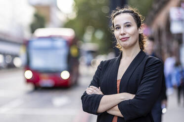 Confident businesswoman with arms crossed in city - WPEF05774