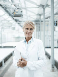 Smiling scientist standing in industry - JOSEF06631