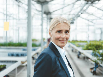 Smiling agronomist in garden center - JOSEF06638