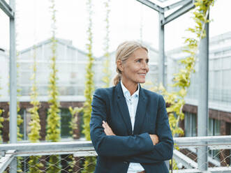 Contemplative biologist in urban garden - JOSEF06670