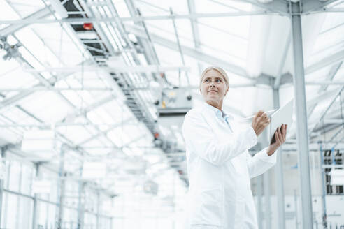 Thoughtful scientist in white lab coat at laboratory - JOSEF06803