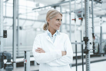 Confident biologist with arms crossed in industry - JOSEF06809