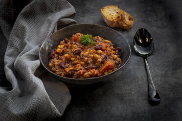 Studio shot of bowl of vegan quinoa stew with vegetables and chick-peas - LVF09196