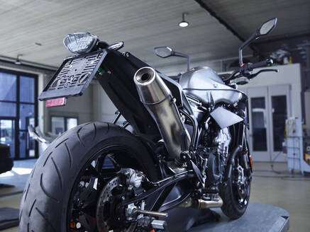 Motorcycle on hydraulic platform at auto repair shop - CVF01888