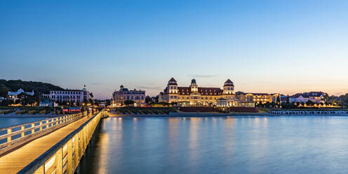 Germany, Mecklenburg-Vorpommern, Binz, Empty pier at dusk with Kurhaus Binz resort background - WDF06766