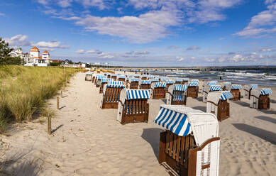 Germany, Mecklenburg-Vorpommern, Binz, Hooded beach chairs on sandy beach of Rugen island - WDF06770