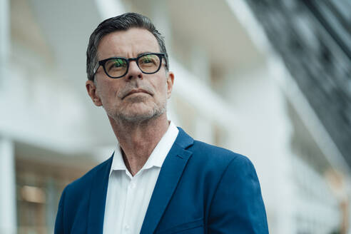 Thoughtful businessman with eyeglasses at office - JOSEF06994