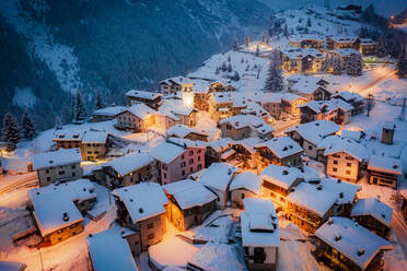 Christmas lights on mountain houses and chalets covered with snow at dusk, Pianazzo, Madesimo, Valle Spluga, Valtellina, Lombardy, Italy, Europe - RHPLF21274