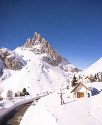 Alpine chapel in the snowy landscape with Sass de Stria peak in the background, Falzarego Pass, Belluno province, Veneto, Italy, Europe - RHPLF21663
