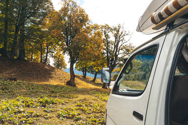 Camper van in autumn forest, Sochi, Krasnaya Polyana, Russia - OMIF00574