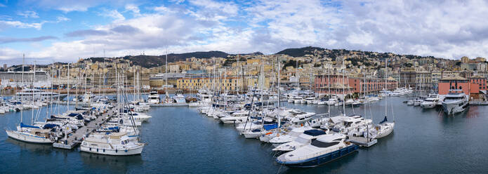 Italy, Liguria, Genoa, Panoramic view of boats moored in city harbor - GIOF14875