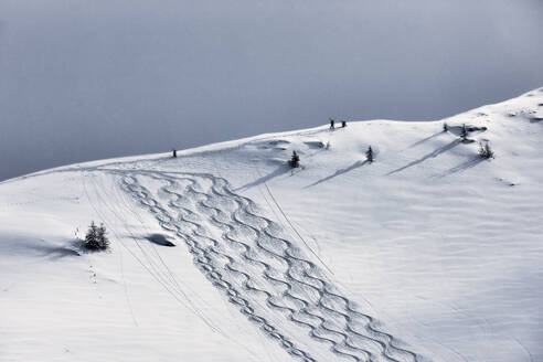 Men walking on snowcapped mountain, Tyrol, Austria - CVF01921