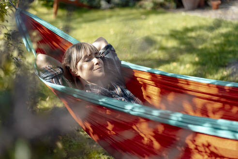 Woman with eyes closed sleeping in hammock - JOSEF07119