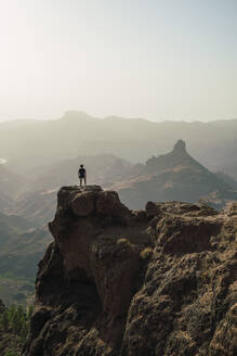 Man standing on mountain peak, Grand Canary, Spain - RSGF00862