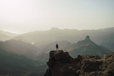 Hiker standing on mountain peak, Grand Canary, Spain - RSGF00863