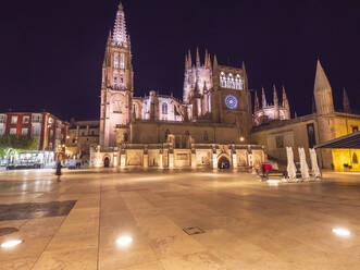 Spain, Castile and Leon, Burgos, Square in front of illuminated Cathedral of Saint Mary of Burgos at night - LAF02752