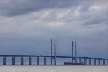 Cloudy sky over container ship sailing under Oresund Bridge - FOF12840