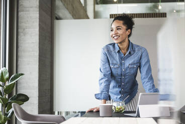 Happy businesswoman day dreaming at work place - UUF25429