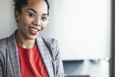 Young businesswoman with eyeglasses in office - UUF25519