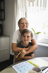 Portrait of smiling sibling in living room at home - MASF28309