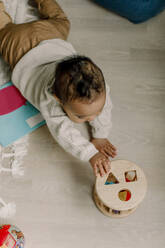 High angle view of baby boy playing with toy at home - MASF28646