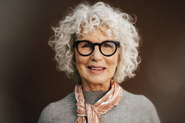 Portrait of senior woman wearing eyeglasses in studio - MASF28738
