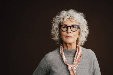 Portrait of confident elderly woman in studio - MASF28740