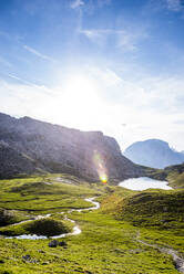 Italy, South Tyrol, View of Puez Group range on sunny summer day with lake in background - EGBF00799