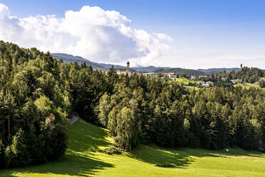 Italy, South Tyrol, Vols am Schlern, Mountain village in summer with green grove in foreground - EGBF00823