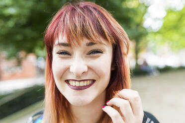 Cheerful redheaded woman with nose ring - WPEF05823
