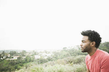 African American man sitting on hilltop - TETF00006