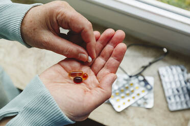 Senior woman with medicine pills in hand - IHF00755