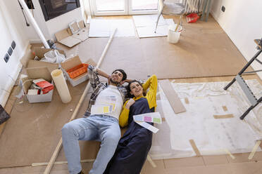 Young couple day dreaming with color swatches at home renovation works - EIF03376