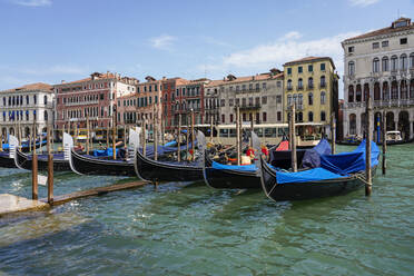 Italy, Veneto, Venice, Gondolas moored along city canal - TAMF03284
