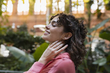 Young woman day dreaming in garden - JCCMF05372