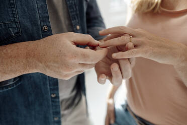 Man giving ring to woman - KNSF09309