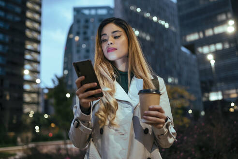 Beautiful woman using smart phone in city - JSRF01867