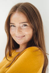 Smiling woman with brown hair in studio - JOSEF07221
