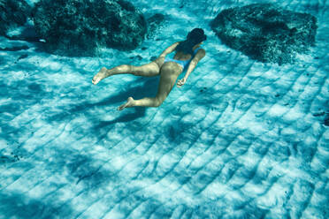 Italy, Sardinia, Woman swimming in sea - ISF25556