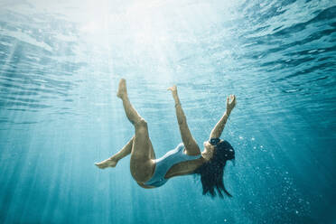 Italy, Sardinia, Woman swimming in sea - ISF25557